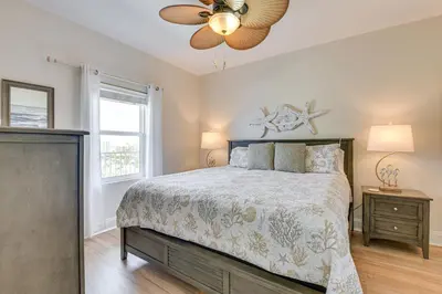 a bedroom with a bed and a ceiling fan at Comfy PCB Condo with View and Private Beach Access! in Panama City Beach