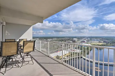 a balcony with chairs and a view of the water at Comfy PCB Condo with View and Private Beach Access! in Panama City Beach