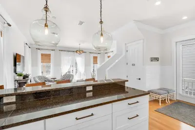 a kitchen with white cabinets and a counter top at La Dolce Vita in Inlet Beach