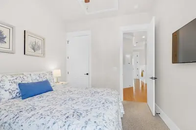 a bedroom with a blue pillow on a bed at La Dolce Vita in Inlet Beach