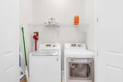 a small kitchen with a washer and dryer in it at La Dolce Vita in Inlet Beach