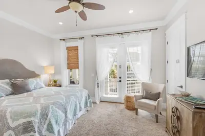 a bedroom with a bed and a ceiling fan at La Dolce Vita in Inlet Beach