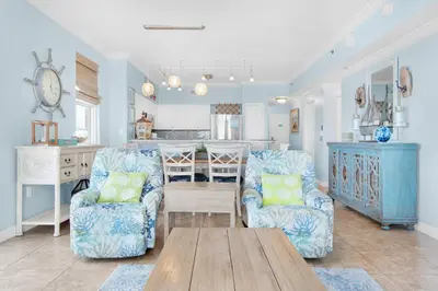 a living room with two chairs and a table at Shores of Panama 1401 in Panama City Beach
