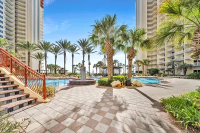 a resort with a swimming pool and palm trees at Shores of Panama 1401 in Panama City Beach