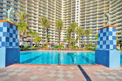 a swimming pool in front of a large apartment building at Shores of Panama 1401 in Panama City Beach