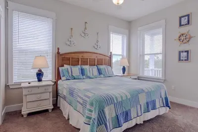a bedroom with a large bed and two windows at Amazing Place - 1232960 in Santa Rosa Beach