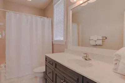 a bathroom with a sink and a toilet and a mirror at Amazing Place - 1232960 in Santa Rosa Beach