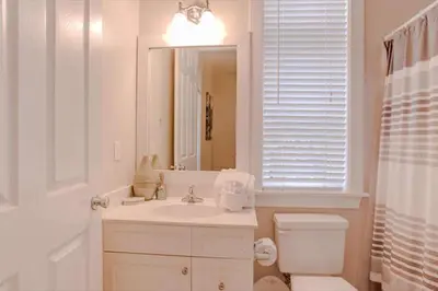 a bathroom with a sink and a toilet and a mirror at Amazing Place - 1232960 in Santa Rosa Beach
