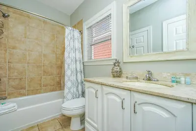 a bathroom with a toilet and a sink and a mirror at DRIFTWOOD COTTAGE at Seacrest Beach - 1581803 in Panama City Beach