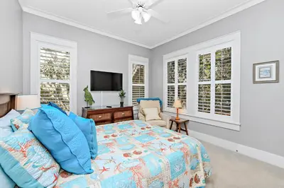 a bedroom with a bed and a flat screen tv at Happy Hour - 1232970 in Rosemary Beach