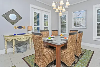 a dining room with a table and chairs at Happy Hour - 1232970 in Rosemary Beach
