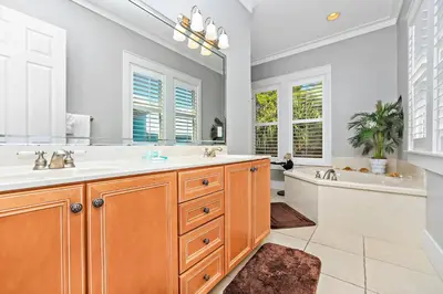 a bathroom with two sinks and a tub and a mirror at Happy Hour - 1232970 in Rosemary Beach