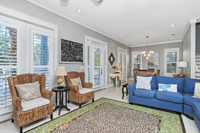a living room with a blue couch and chairs at Happy Hour - 1232970 in Rosemary Beach