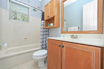 a bathroom with a toilet and a sink and a mirror at Happy Hour - 1232970 in Rosemary Beach