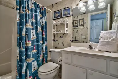 a bathroom with a toilet and a sink and a shower curtain at Pirate Cove Villa 117 - 825255 in Panama City Beach