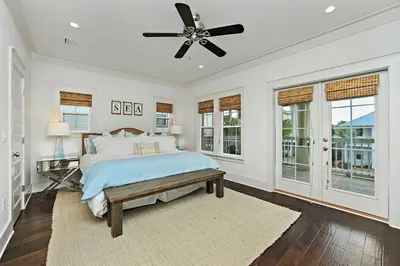 a bedroom with a bed and a ceiling fan at Seas The Day at Seacrest - 1228999 in Panama City Beach