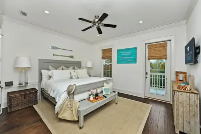 a bedroom with a bed and a ceiling fan at Seas The Day at Seacrest - 1228999 in Panama City Beach
