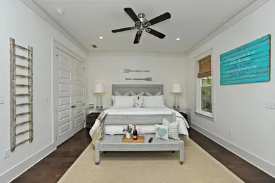 a bedroom with a bed and a ceiling fan at Seas The Day at Seacrest - 1228999 in Panama City Beach