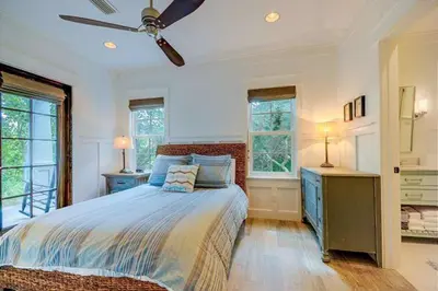 a bedroom with a bed and a ceiling fan at The White House - 1232985 in Santa Rosa Beach