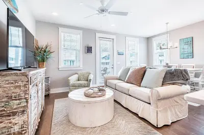 a living room with a couch and a tv at Inn to the Mystic in Santa Rosa Beach