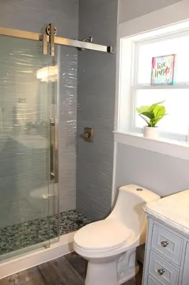 a bathroom with a toilet and a glass shower at Beach Beyond Belief House & private pool & free bikes & private beach in Rosemary Beach