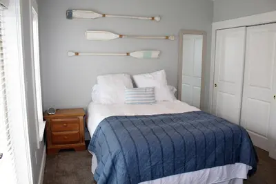a bedroom with a bed with a blue blanket at Beach Beyond Belief House & private pool & free bikes & private beach in Rosemary Beach