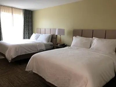 a hotel room with two beds and a window at Candlewood Suites - Panama City Beach Pier Park by IHG in Panama City Beach