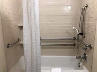 a bathroom with a shower curtain and a bath tub at Candlewood Suites - Panama City Beach Pier Park by IHG in Panama City Beach