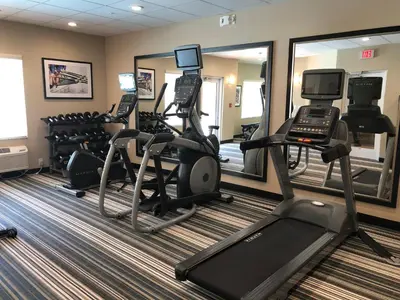 a fitness room with treadmills and elliptical machines at Candlewood Suites - Panama City Beach Pier Park by IHG in Panama City Beach