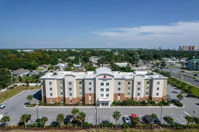 an aerial view of a hotel with a parking lot at Candlewood Suites - Panama City Beach Pier Park by IHG in Panama City Beach