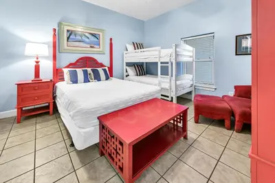a room with a bedroom with a bed and a couch at Ocean Ritz 1902 in Panama City Beach