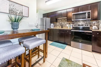 a large kitchen with wooden cabinets and stainless steel appliances at Merrimac Resort #32 in Panama City Beach