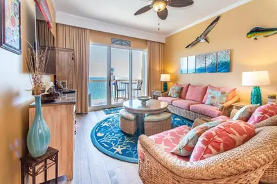 a living room with a couch and a table at Calypso 2-2304 West in Panama City Beach