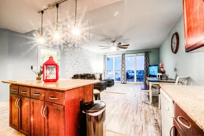 a kitchen and living room with a counter top at Laketown Wharf 534 By Aneliya in Panama City Beach
