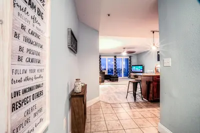 a living room with a wall with writing on it at Laketown Wharf 534 By Aneliya in Panama City Beach