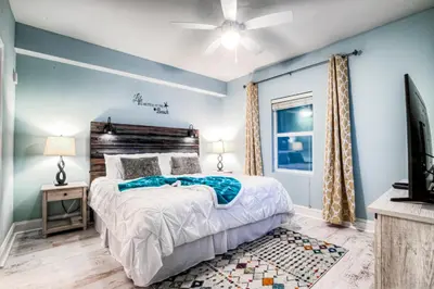 a bedroom with a bed and a ceiling fan at Laketown Wharf 534 By Aneliya in Panama City Beach