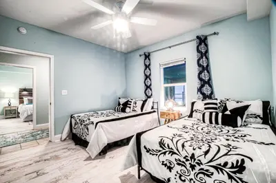 a bedroom with two beds and a ceiling fan at Laketown Wharf 534 By Aneliya in Panama City Beach