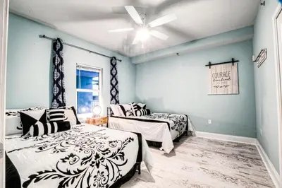 a bedroom with two beds and a ceiling fan at Laketown Wharf 534 By Aneliya in Panama City Beach