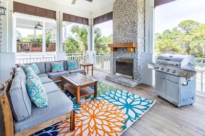 a living room with a couch and a fireplace at Stay Salty in Santa Rosa Beach