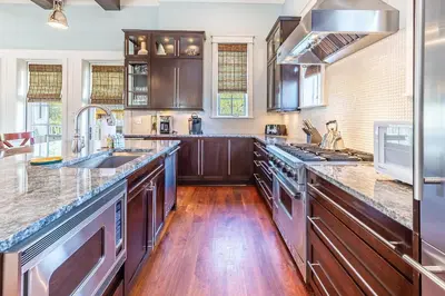 a kitchen with wooden cabinets and a large counter top at Stay Salty in Santa Rosa Beach