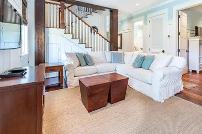 a living room with a white couch and a table at Stay Salty in Santa Rosa Beach
