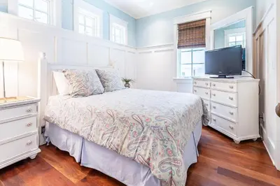 a bedroom with a bed and a flat screen tv at Stay Salty in Santa Rosa Beach