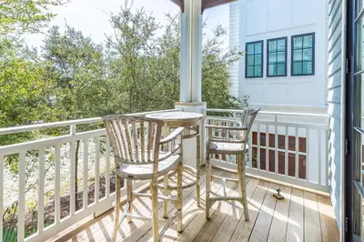 a porch with two chairs and a table at Stay Salty in Santa Rosa Beach