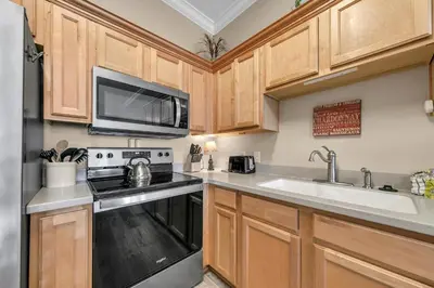 a kitchen with a stove microwave and a sink at Churchill By The Sea 2308 in Santa Rosa Beach