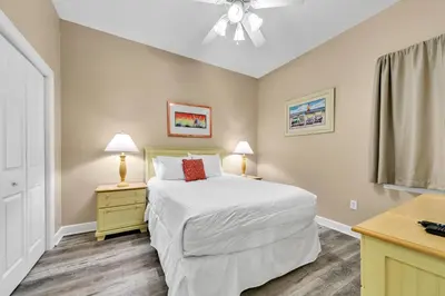 a bedroom with a bed and two night stands and two lamps at Churchill By The Sea 2308 in Santa Rosa Beach