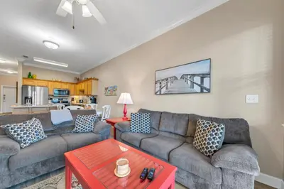 a living room with two couches and a table at Churchill By The Sea 2308 in Santa Rosa Beach