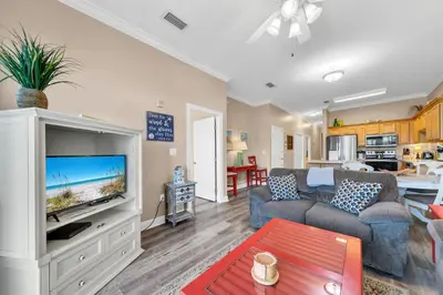 a living room with a couch and a tv at Churchill By The Sea 2308 in Santa Rosa Beach