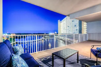a room with a balcony with a view of the water at Laketown Wharf 734 By Aneliya in Panama City Beach