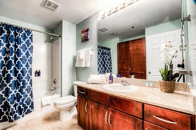 a bathroom with a sink and a toilet and a shower at Laketown Wharf 734 By Aneliya in Panama City Beach