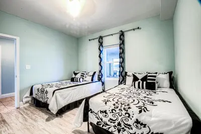 a bedroom with two beds and a window at Laketown Wharf 734 By Aneliya in Panama City Beach